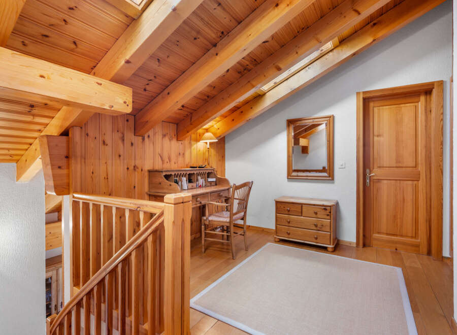 This charming property boasts a warm and inviting interior with beautiful wooden accents throughout.