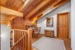 This charming property boasts a warm and inviting interior with beautiful wooden accents throughout.