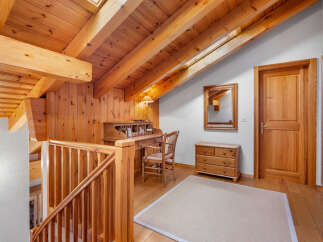 This charming property boasts a warm and inviting interior with beautiful wooden accents throughout.