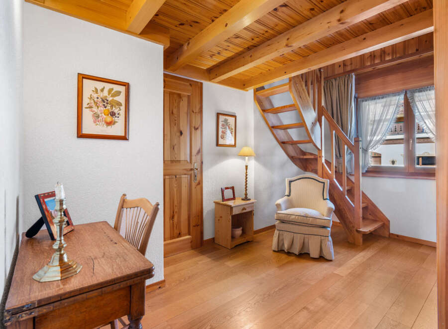 This charming property features a warm and inviting interior with beautiful wooden accents throughout.