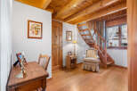 This charming property features a warm and inviting interior with beautiful wooden accents throughout.