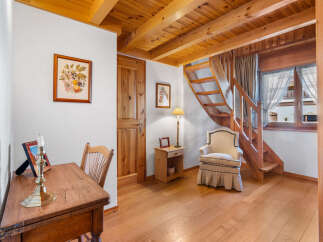 This charming property features a warm and inviting interior with beautiful wooden accents throughout.