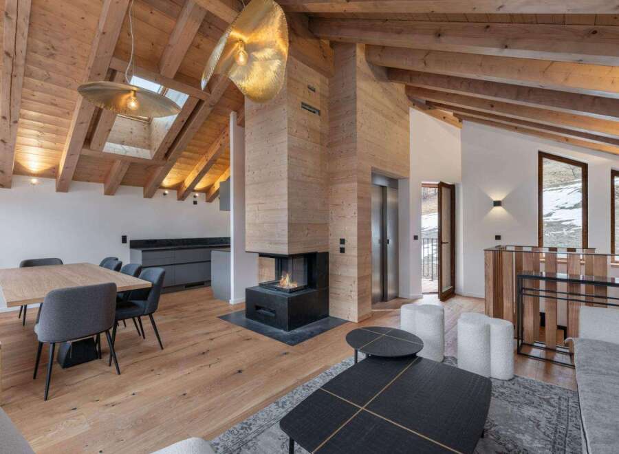This stunning property boasts a modern interior with a cozy fireplace, perfect for those chilly evenings.