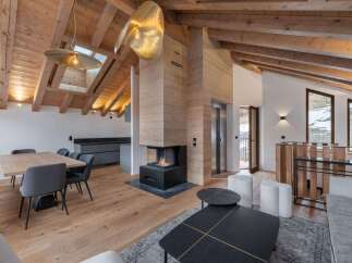 This stunning property boasts a modern interior with a cozy fireplace, perfect for those chilly evenings.