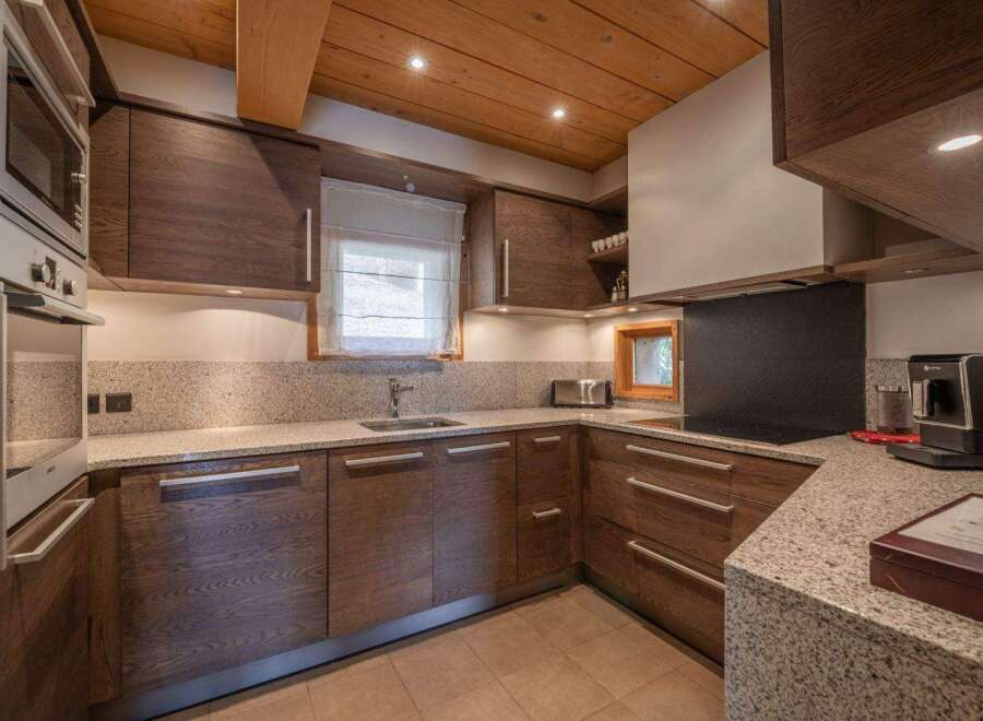 This stunning kitchen boasts a modern design with high-end appliances and ample counter space.