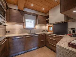 This stunning kitchen boasts a modern design with high-end appliances and ample counter space.