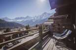 Enjoy breathtaking mountain views from this stunning chalet balcony.