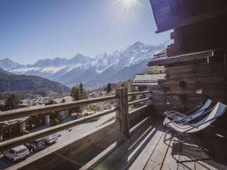 Enjoy breathtaking mountain views from this stunning chalet balcony.