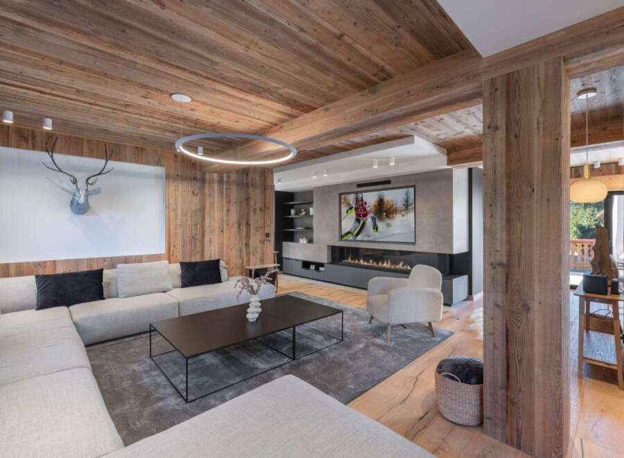 Experience luxury living in this stunning property, featuring a cozy living room with a fireplace and a modern design.