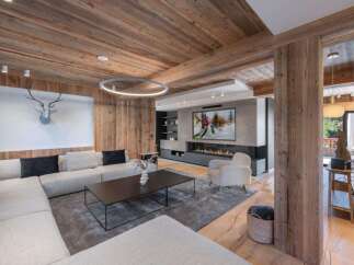 Experience luxury living in this stunning property, featuring a cozy living room with a fireplace and a modern design.