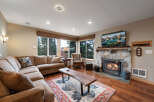 Step into cozy luxury with this stunning living room! Featuring a stone fireplace, hardwood floors, and a comfortable sectional sofa, it's the perfect space for relaxation and entertaining.