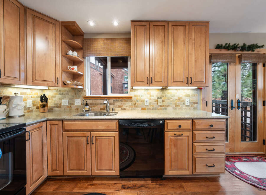 This stunning kitchen boasts beautiful wooden cabinetry, offering ample storage and a warm, inviting atmosphere.