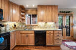 This stunning kitchen boasts beautiful wooden cabinetry, offering ample storage and a warm, inviting atmosphere.