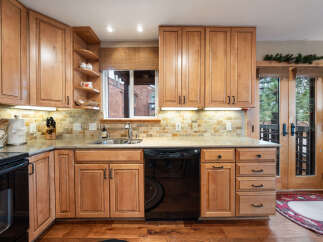 This stunning kitchen boasts beautiful wooden cabinetry, offering ample storage and a warm, inviting atmosphere.
