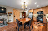 This charming property features a cozy dining area with a rustic wooden table and comfortable seating, perfect for intimate gatherings.