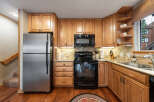 This stunning kitchen boasts beautiful wooden cabinetry and modern appliances, creating a warm and inviting atmosphere.