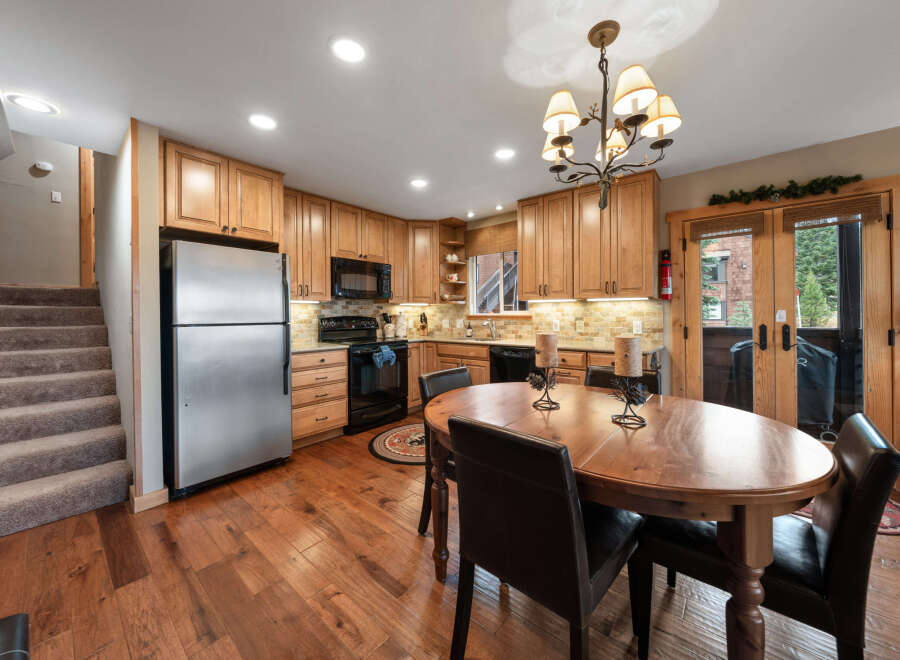 This stunning kitchen boasts beautiful wooden cabinetry and flooring, creating a warm and inviting atmosphere.