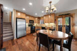 This stunning kitchen boasts beautiful wooden cabinetry and flooring, creating a warm and inviting atmosphere.
