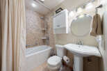 This charming bathroom features a stylish combination of functionality and design.