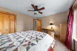 This cozy bedroom features a charming quilt-covered bed, perfect for a relaxing retreat.