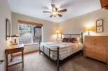 This cozy bedroom features a comfortable bed with a stylish quilt and decorative pillows, perfect for a relaxing retreat.