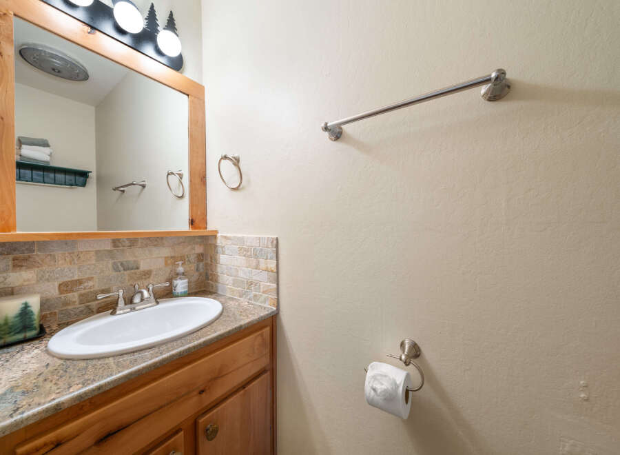 This charming bathroom features a stylish vanity with a sleek sink and a beautiful countertop.