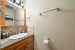 This charming bathroom features a stylish vanity with a sleek sink and a beautiful countertop.