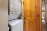 This stunning property boasts a convenient laundry area, featuring a modern stacked washer and dryer.