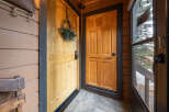Step into a welcoming entryway with a charming wooden door adorned with a festive wreath.