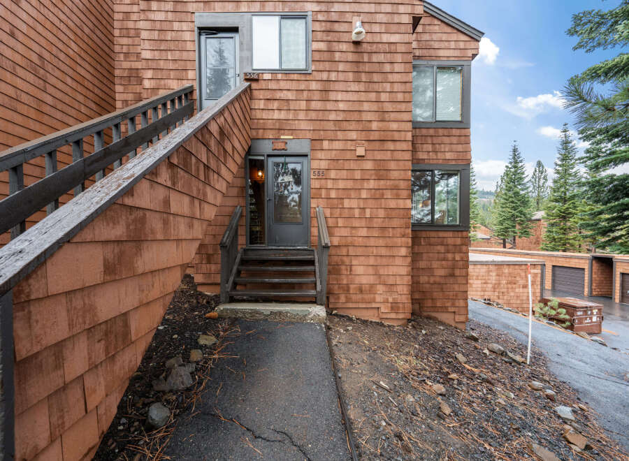 This charming property features a unique exterior design with wooden shingles, creating a warm and inviting atmosphere.
