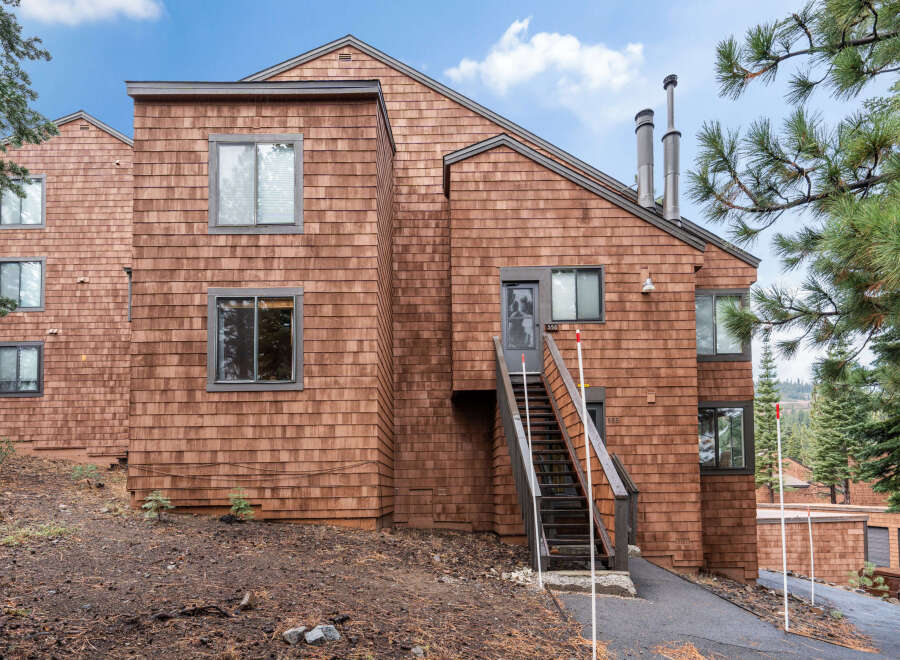 This stunning property boasts a unique architectural design with cedar shake siding, offering a warm and inviting aesthetic.