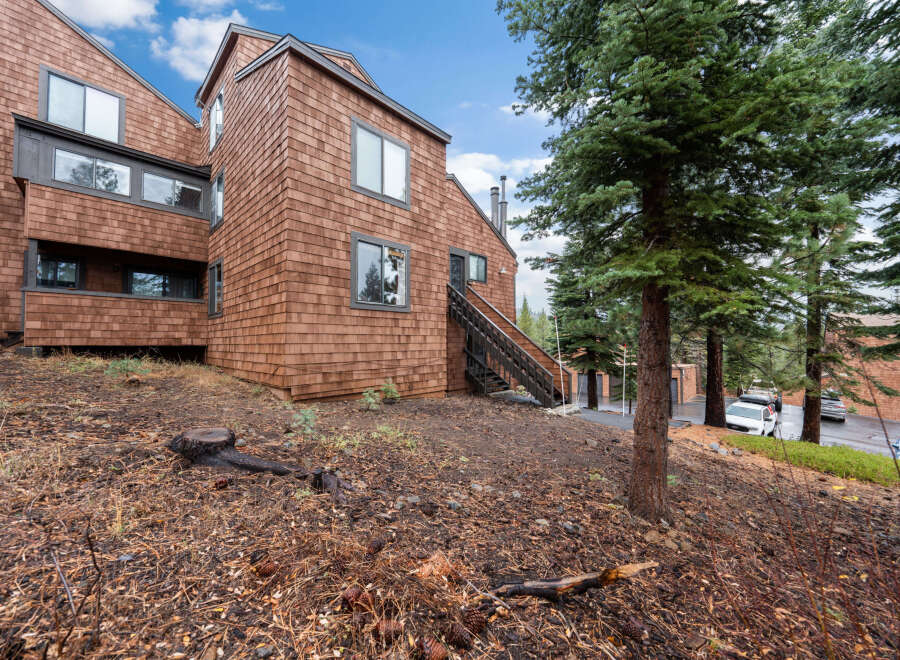 Nestled in a serene, wooded area, this charming property boasts a unique architectural design with cedar shake siding.