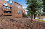 Nestled in a serene, wooded area, this charming property boasts a unique architectural design with cedar shake siding.