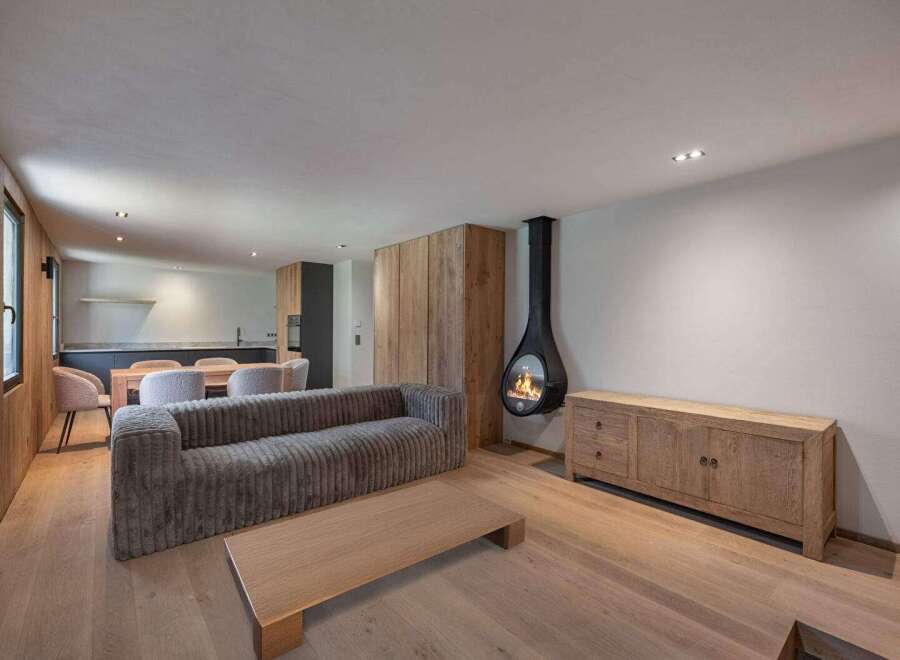 This stunning living space boasts a modern design with a cozy fireplace, perfect for relaxing evenings.