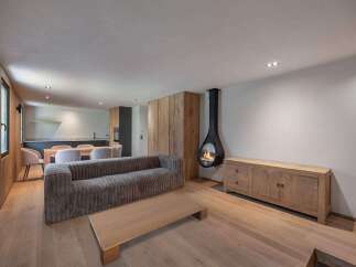 This stunning living space boasts a modern design with a cozy fireplace, perfect for relaxing evenings.