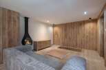 This stunning living space boasts a modern fireplace, creating a warm and inviting atmosphere.
