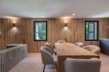 This stunning dining area boasts a warm and inviting atmosphere, perfect for gatherings and meals.