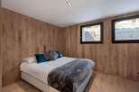 This cozy bedroom features stunning wood paneling that adds warmth and character to the space.