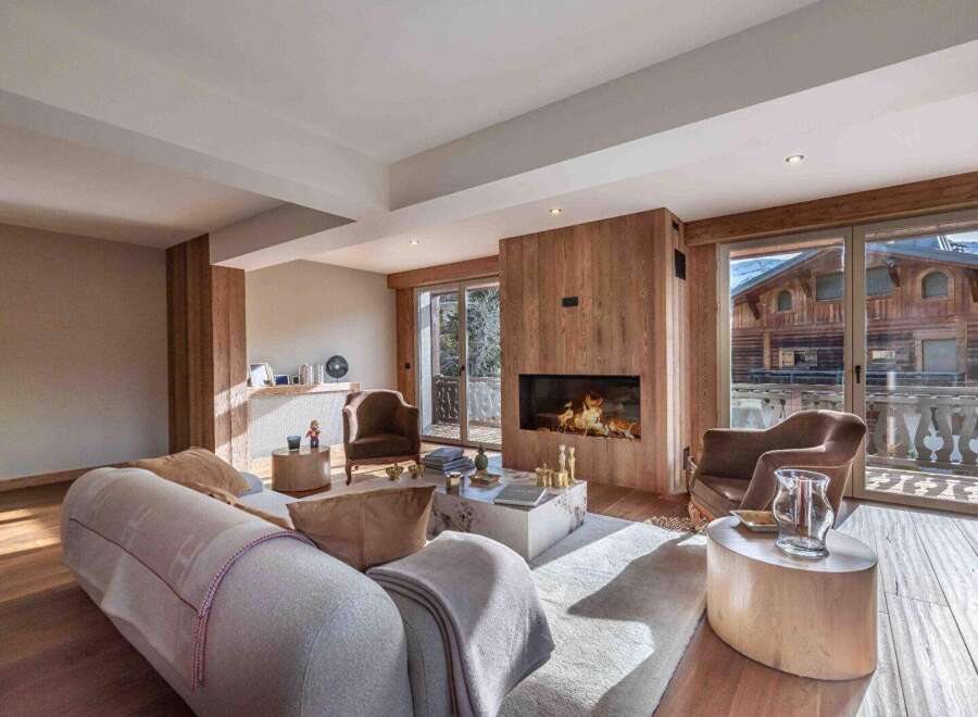 Experience luxury living in this stunning property featuring a cozy fireplace and elegant wooden accents.
