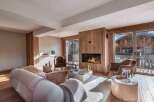 Experience luxury living in this stunning property featuring a cozy fireplace and elegant wooden accents.