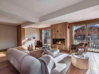 Experience luxury living in this stunning property featuring a cozy fireplace and elegant wooden accents.
