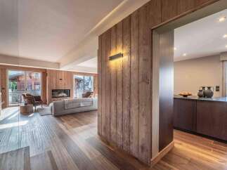 Experience the warmth and elegance of this stunning property, featuring exquisite wood paneling and flooring throughout.