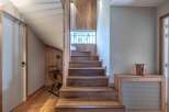 This stunning property boasts a beautifully crafted wooden staircase, creating a warm and inviting atmosphere.
