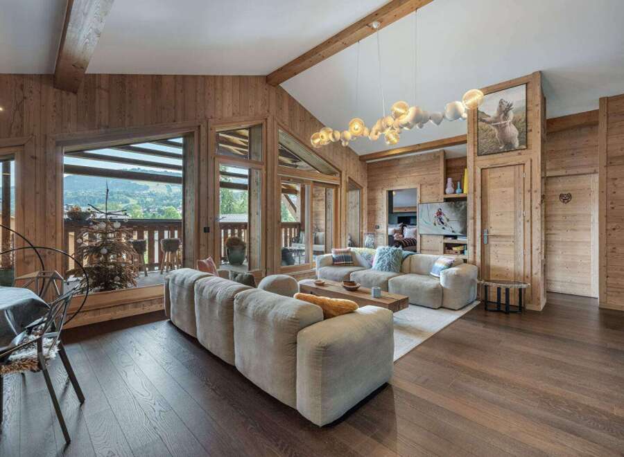 Experience luxury living in this stunning property, featuring a spacious living room with a cozy fireplace and large windows offering breathtaking views.