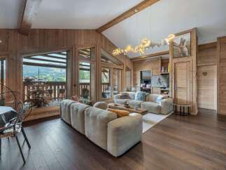 Experience luxury living in this stunning property, featuring a spacious living room with a cozy fireplace and large windows offering breathtaking views.