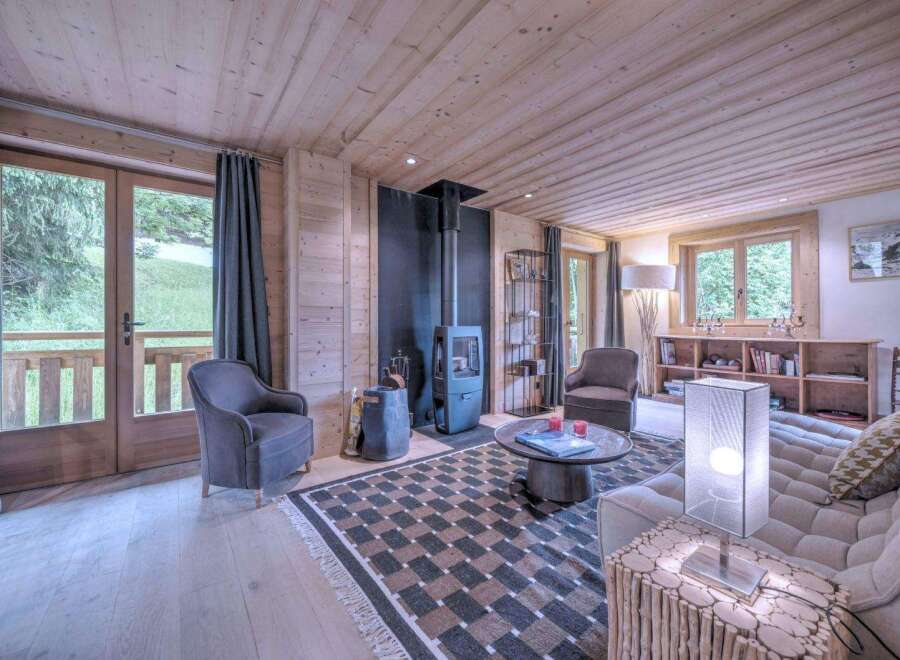 Step into a cozy living space with stunning wooden accents and a modern fireplace, perfect for relaxing evenings.