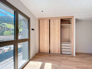 Discover the elegance of this modern bedroom, featuring a spacious built-in wardrobe with sliding doors, offering ample storage.