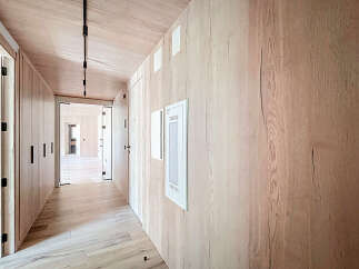 Step into luxury with this stunning hallway, showcasing exquisite wood paneling and a modern design.