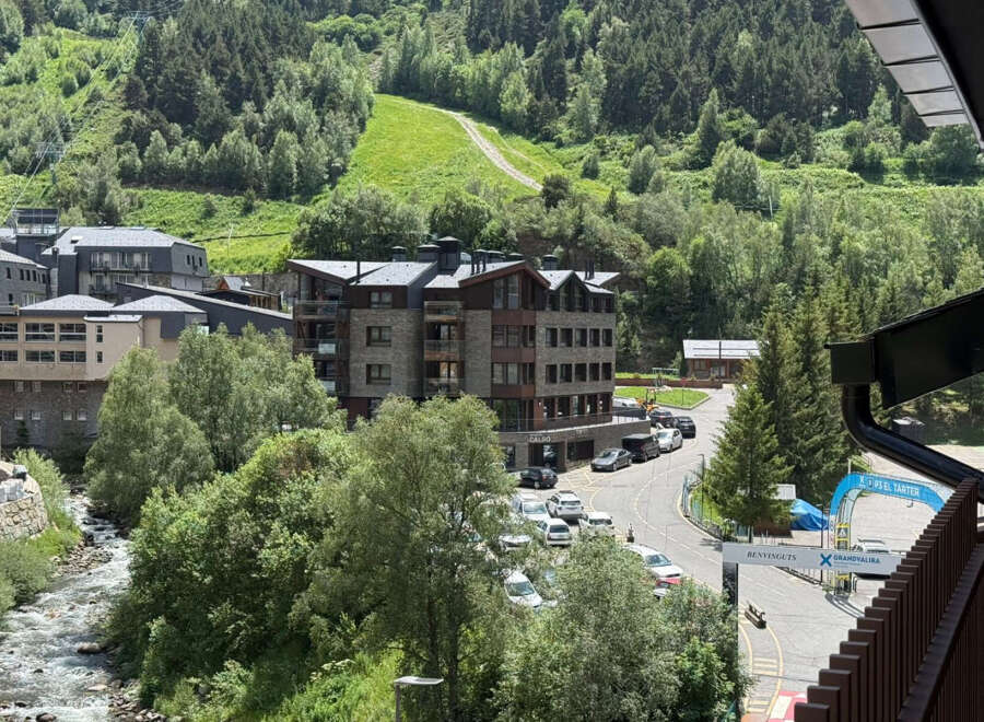 Experience mountain living in this stunning property nestled amidst lush greenery and a flowing river.