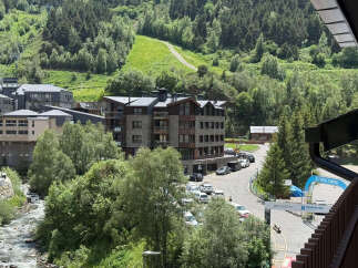 Experience mountain living in this stunning property nestled amidst lush greenery and a flowing river.